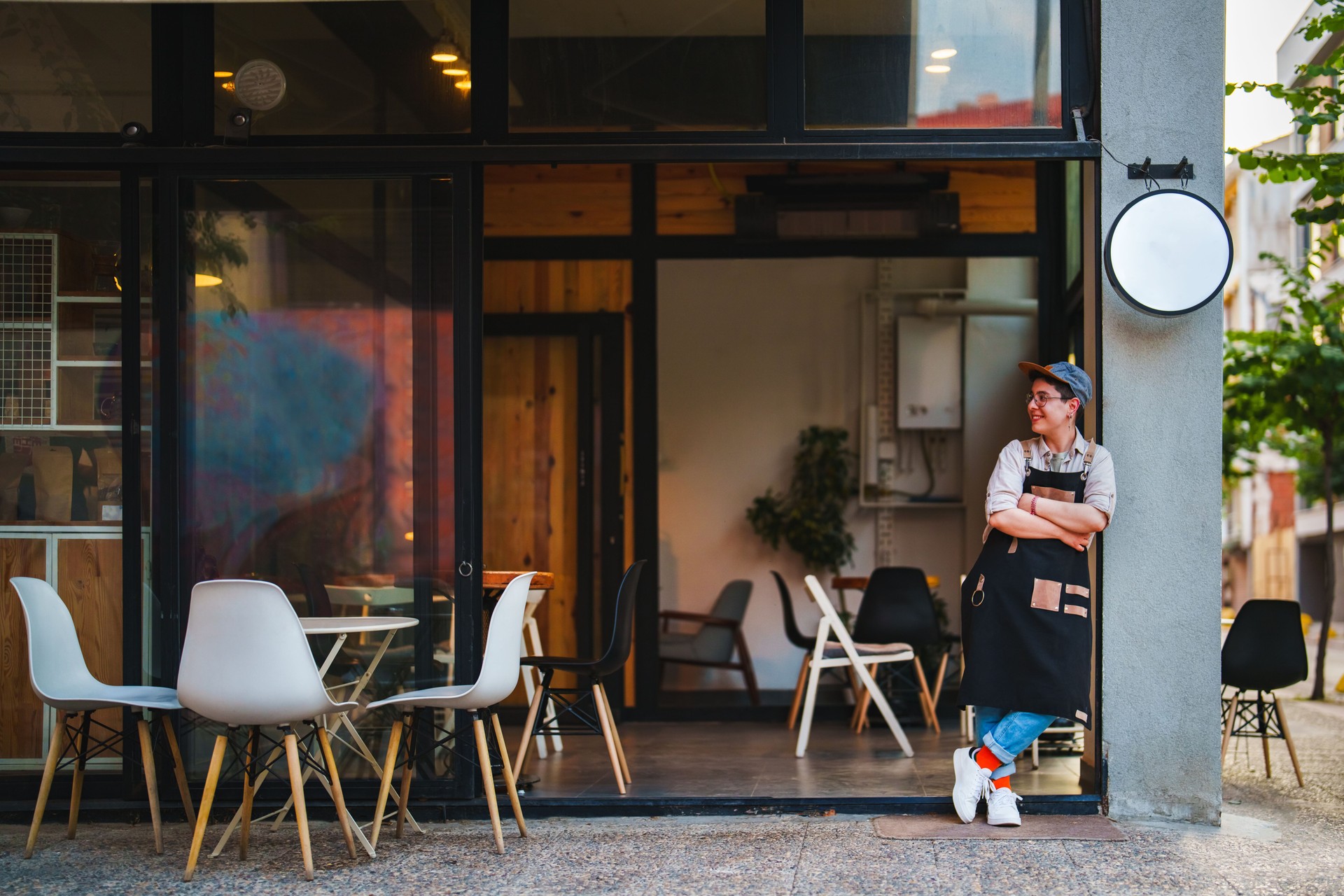 Female Barista opening her coffee shop in the morning.